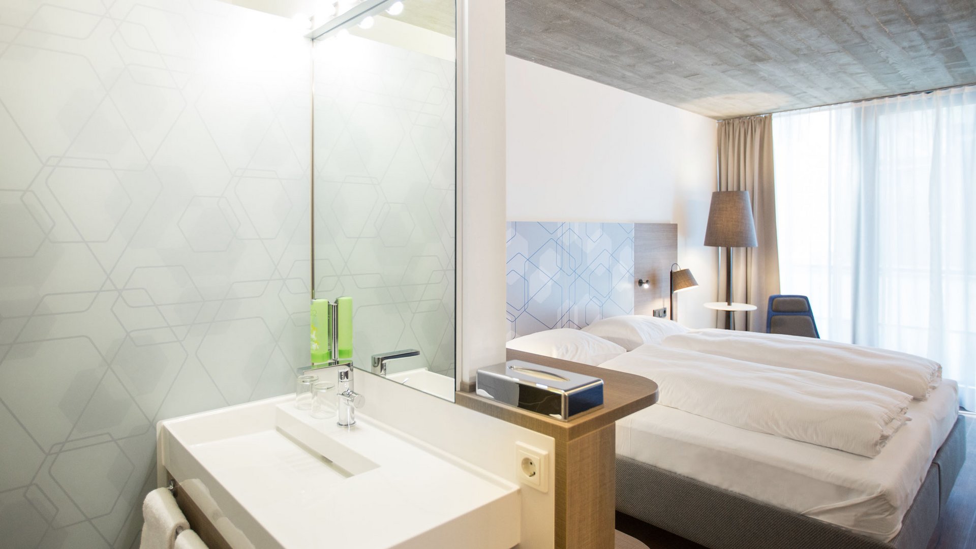 Modern bedroom with double bed and sink area