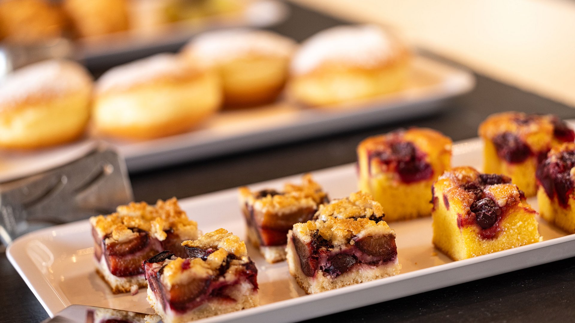 Small fruit cake pieces served on a white rectangular plate