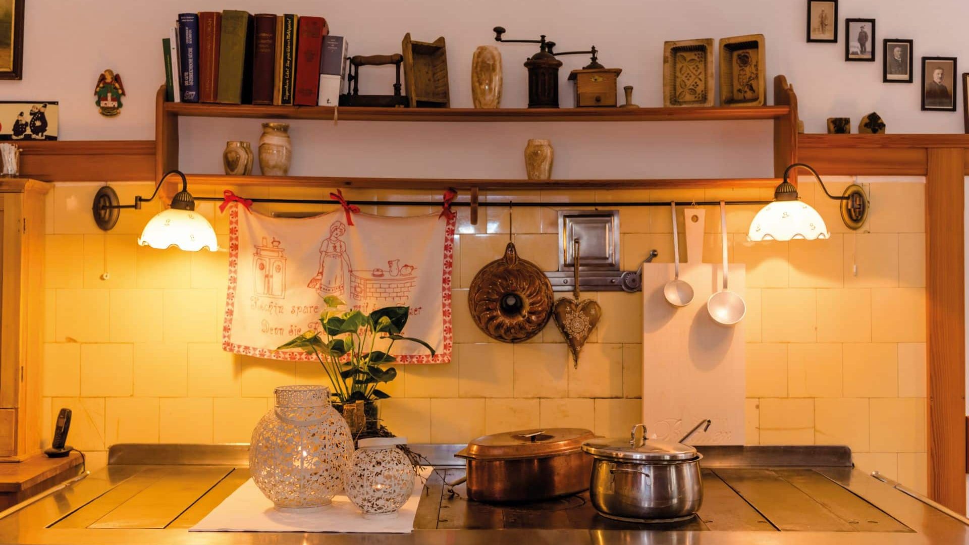 Retro kitchen with old pots, lighting, and decorative items