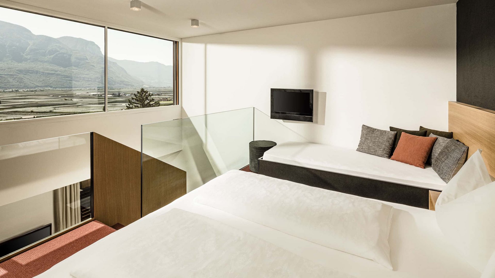 Modern bedroom with large windows and mountain view