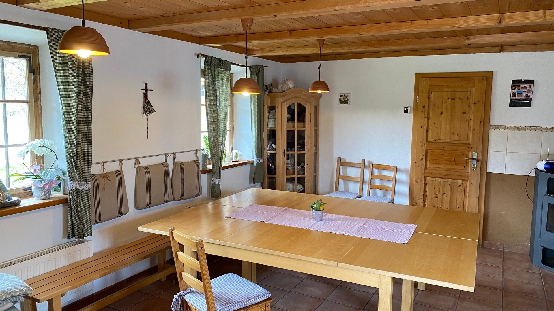 Bright dining area with wooden table and chairs in a cozy room