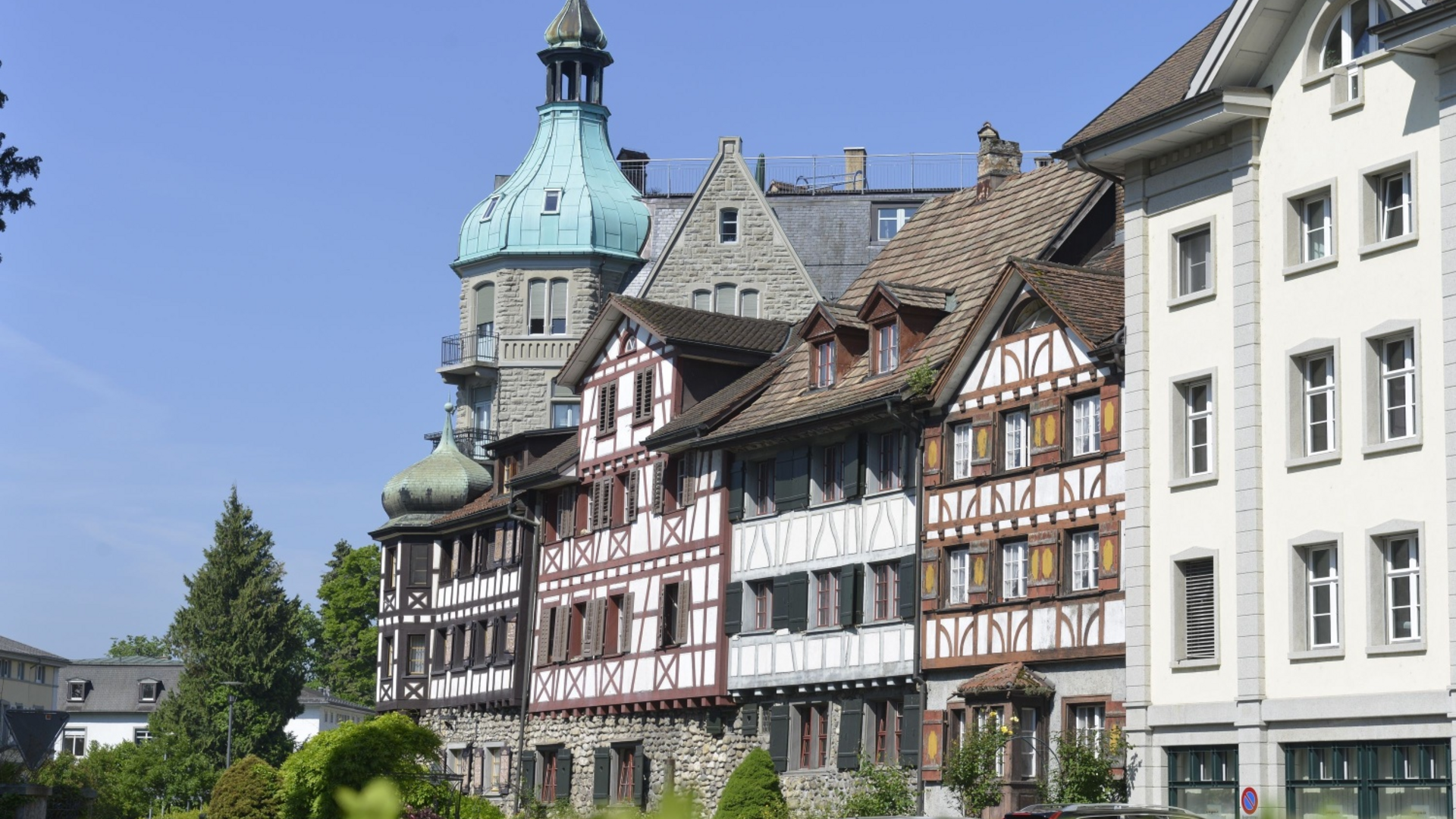 Historic half-timbered houses and a tower in a Swiss town