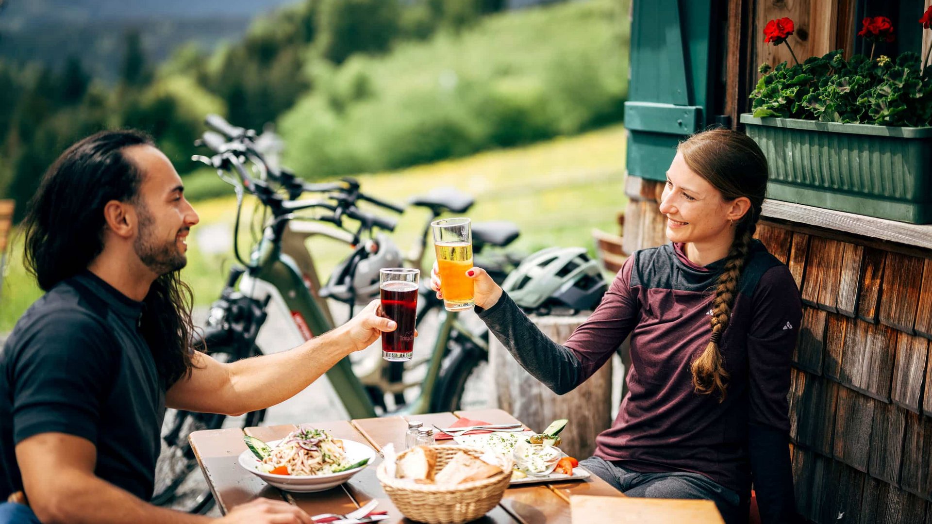 Victoria Couple with bikes drinking beverages while dining outdoors