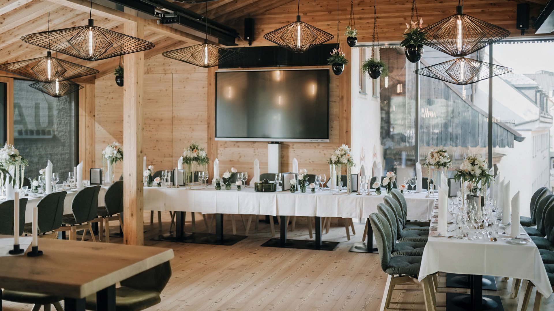 Elegant set event room with wooden walls and modern hanging lights