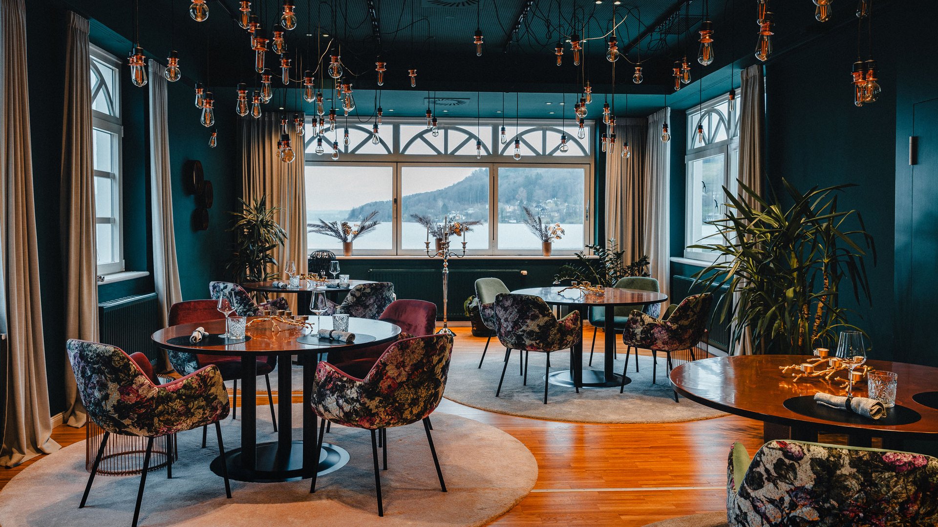 Elegant restaurant with floral chairs and snowy landscape view