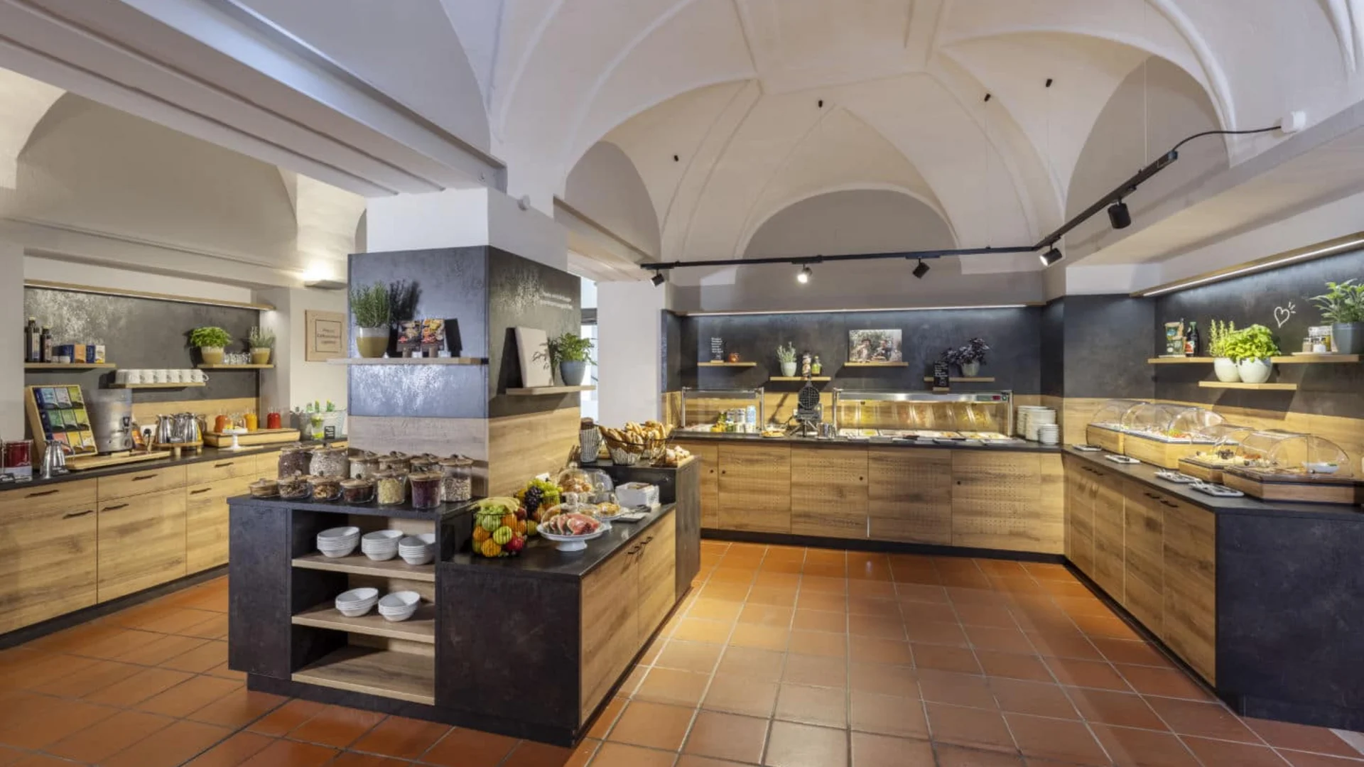 Modern buffet with breakfast and snacks in a room with vaulted ceilings