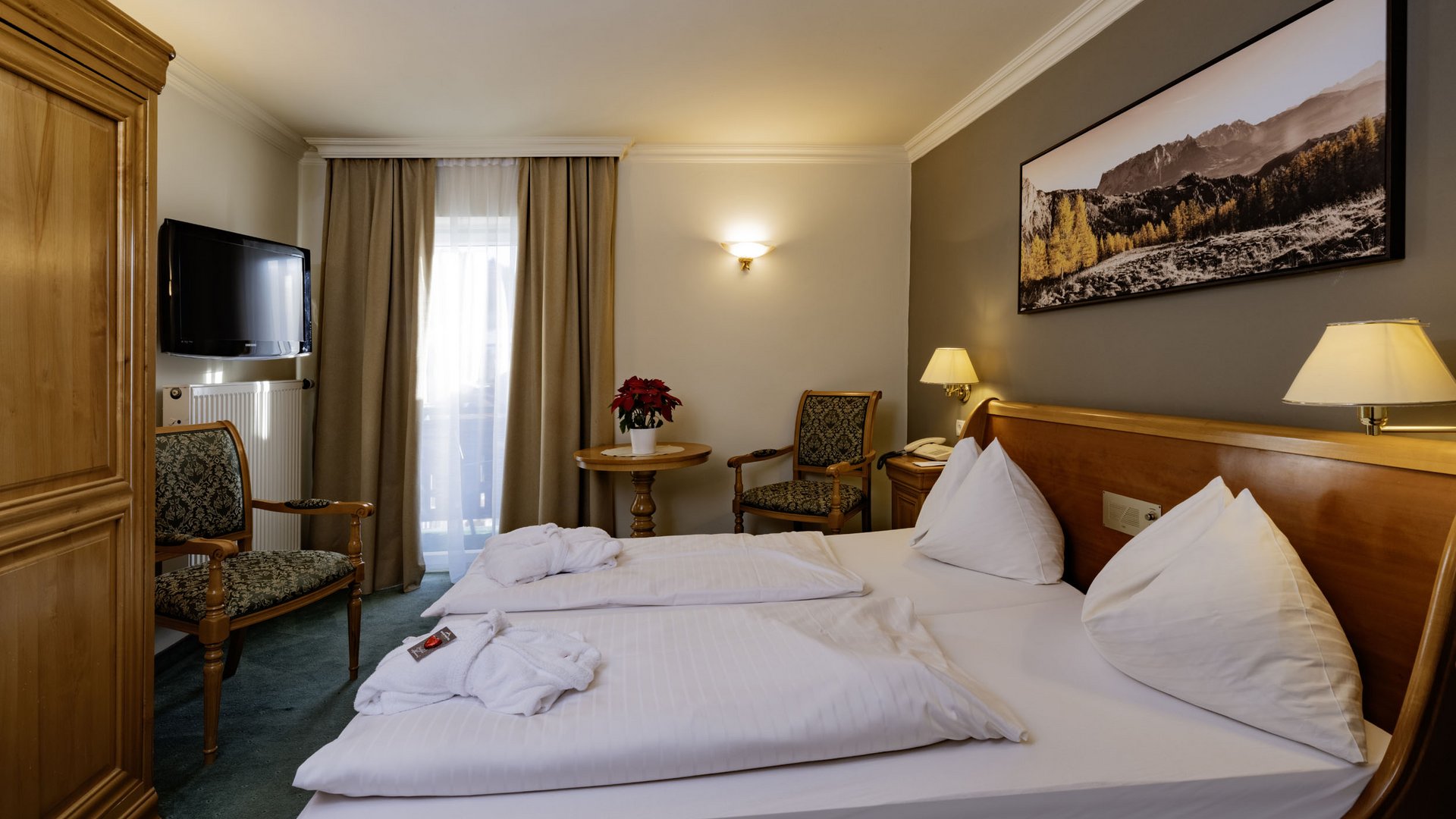 Cozy hotel room with double bed and wooden furniture