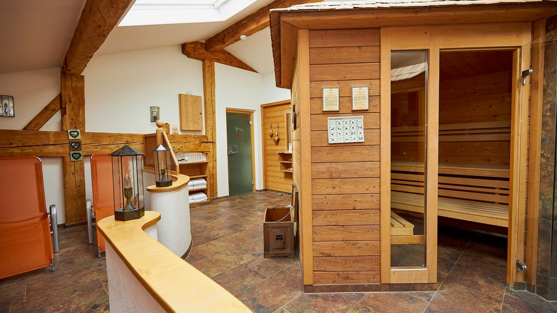 Interior view of a wellness area with sauna and relaxation chairs