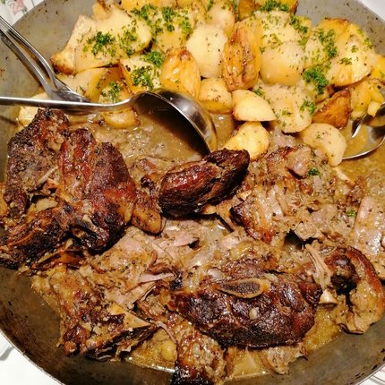 Grilled meat with roasted potatoes served on a plate