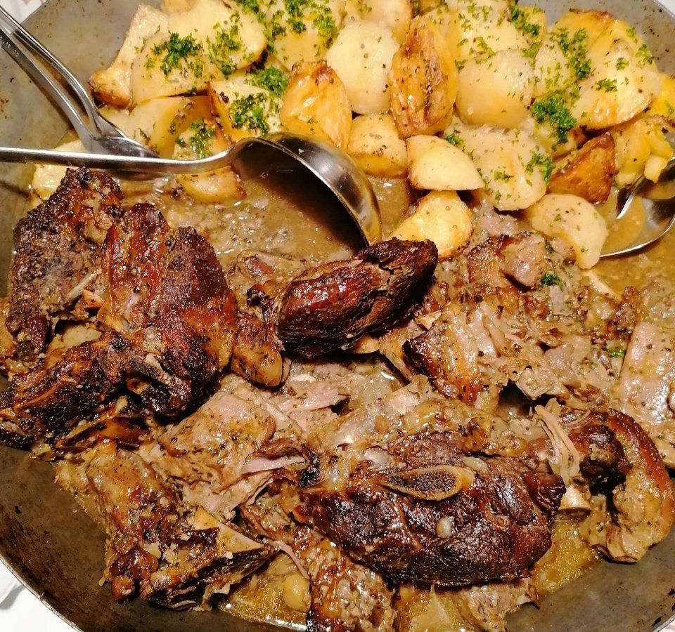 Grilled meat with roasted potatoes served on a plate