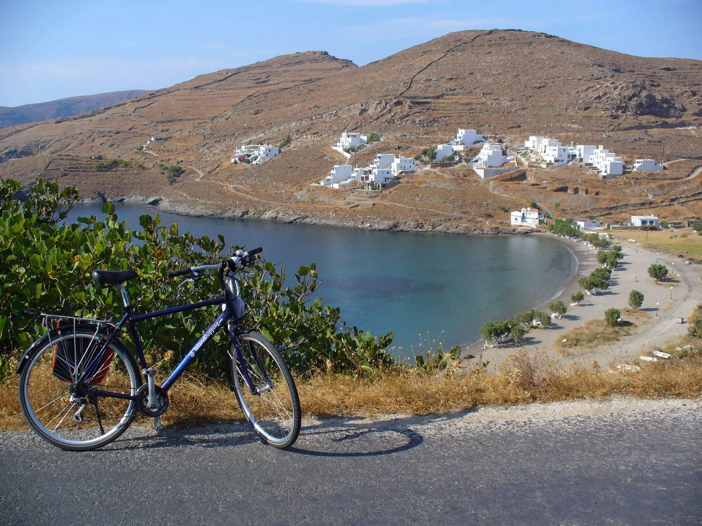 Fahrrad an Bergstraße mit Blick auf Bucht und weiße Häuser am Hügel