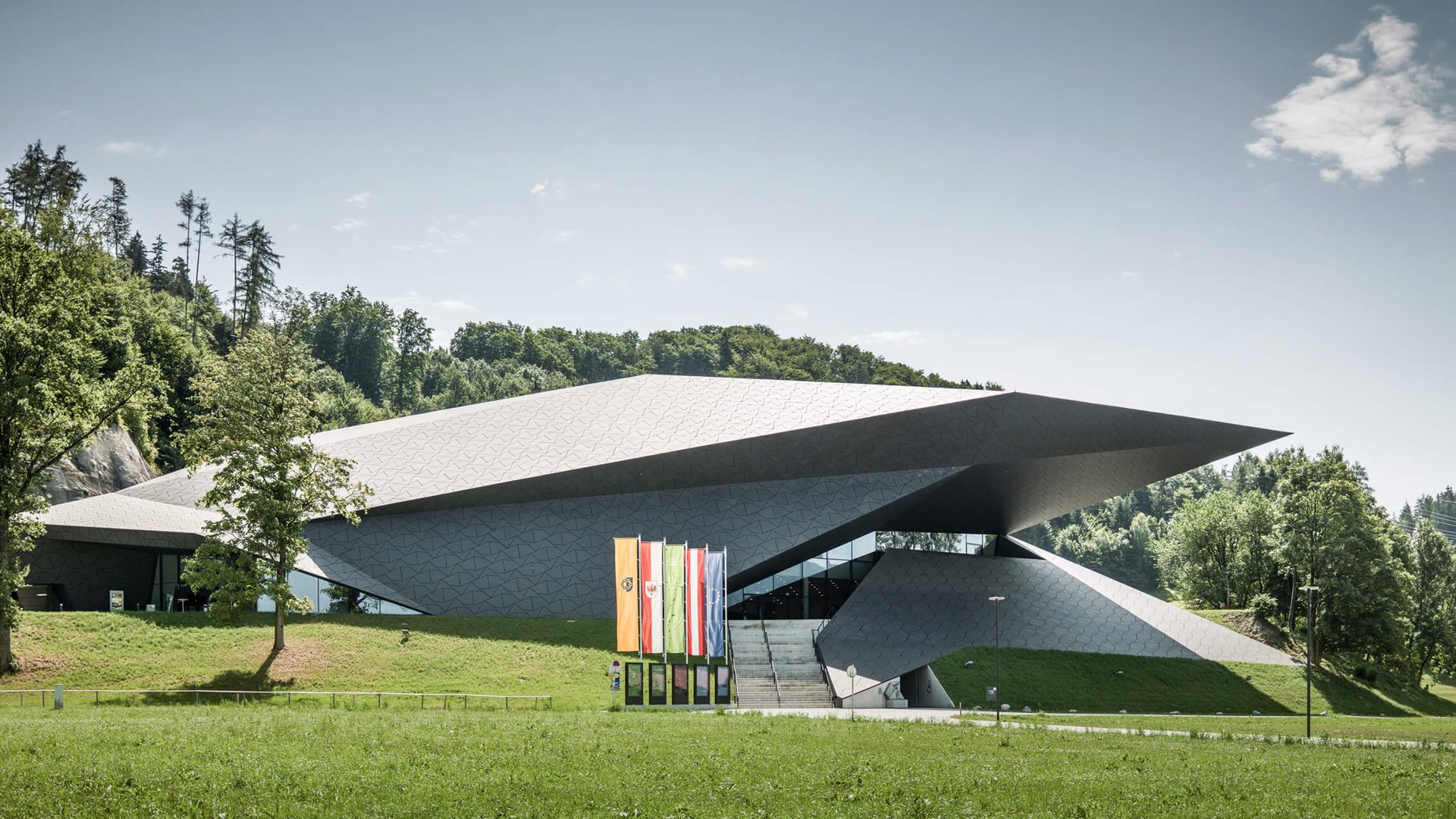 Modern cultural center with unique architecture set in green landscape