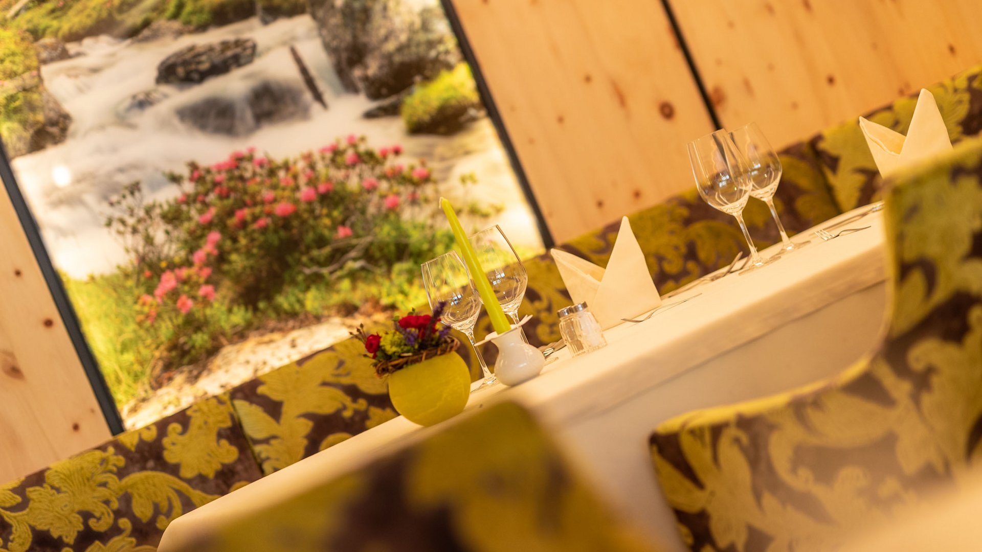 Elegant set dining table with flowers and candle in cozy restaurant