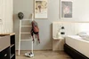 Collective enquiries Hotel room with cycling gear next to bed and framed wall art