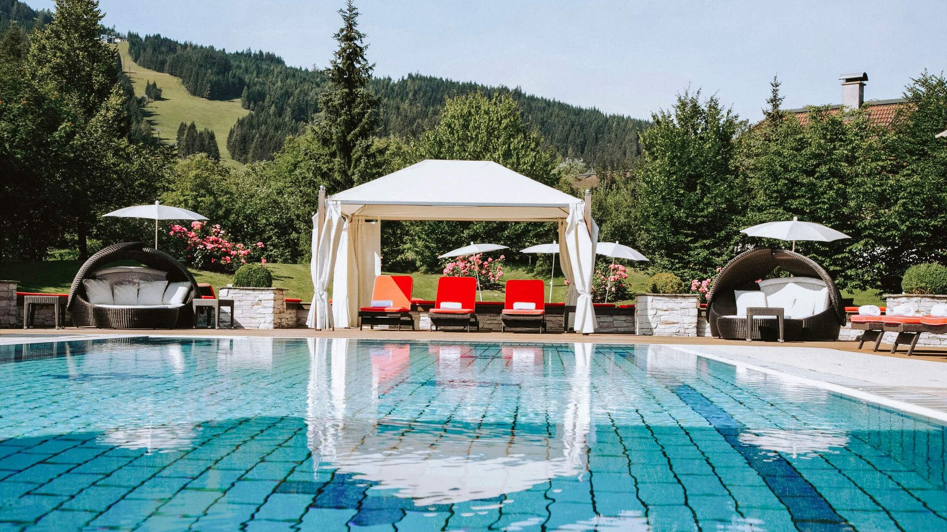 Swimming pool with lounge chairs, canopy, and mountain view