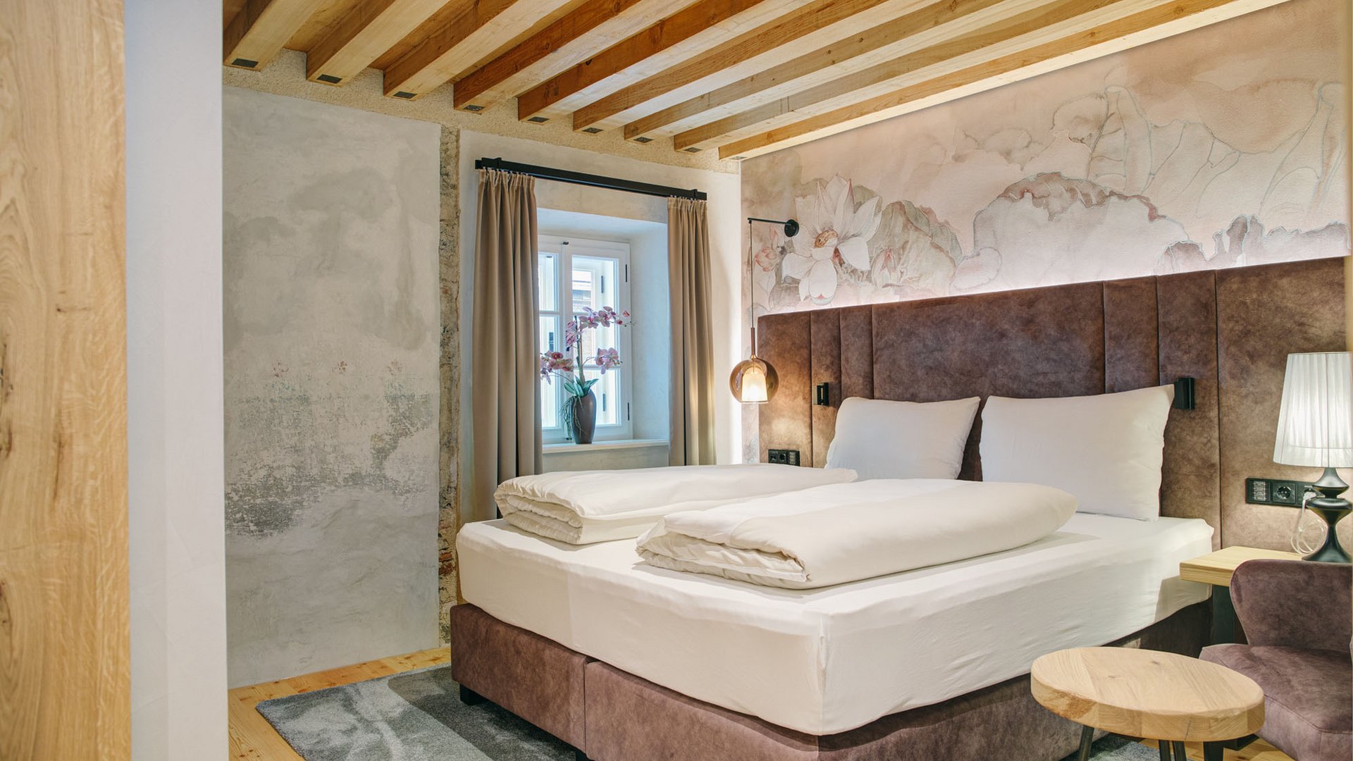 Cozy bedroom with double bed and floral wall decor