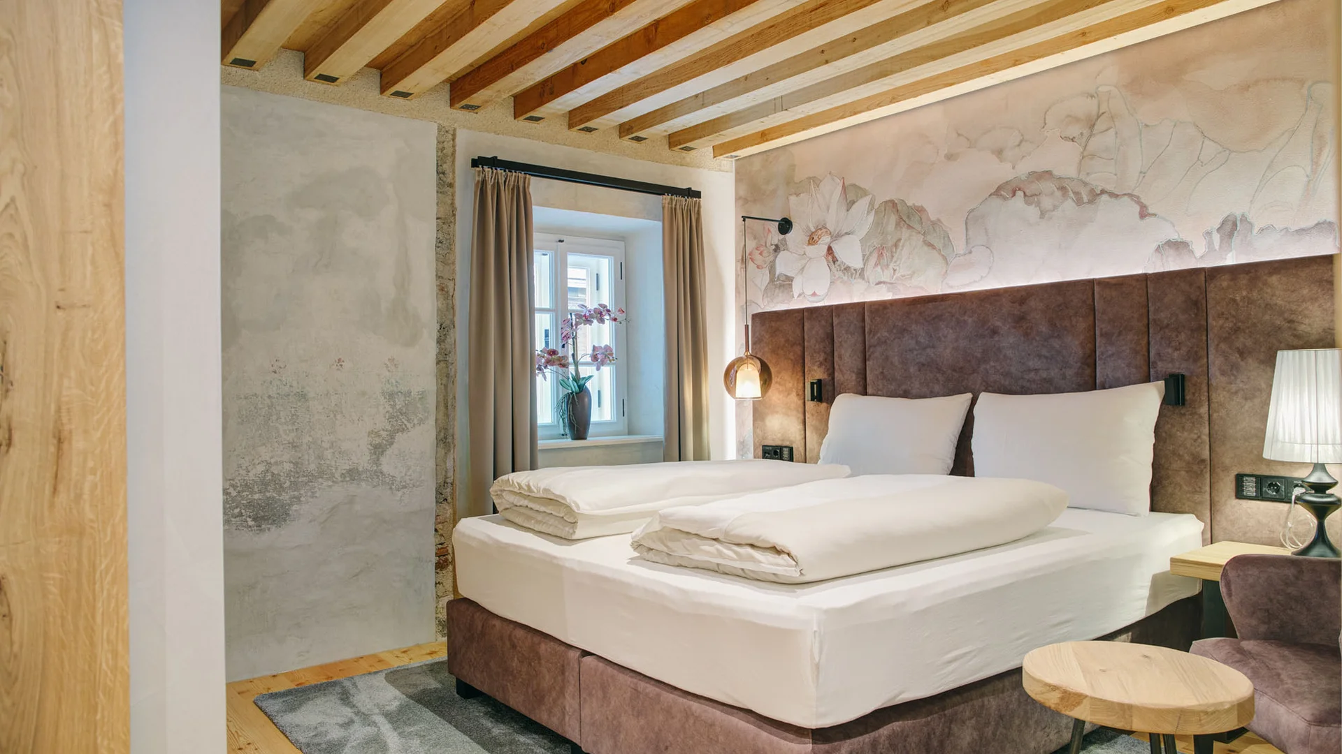 Cozy bedroom with double bed and floral wall decor