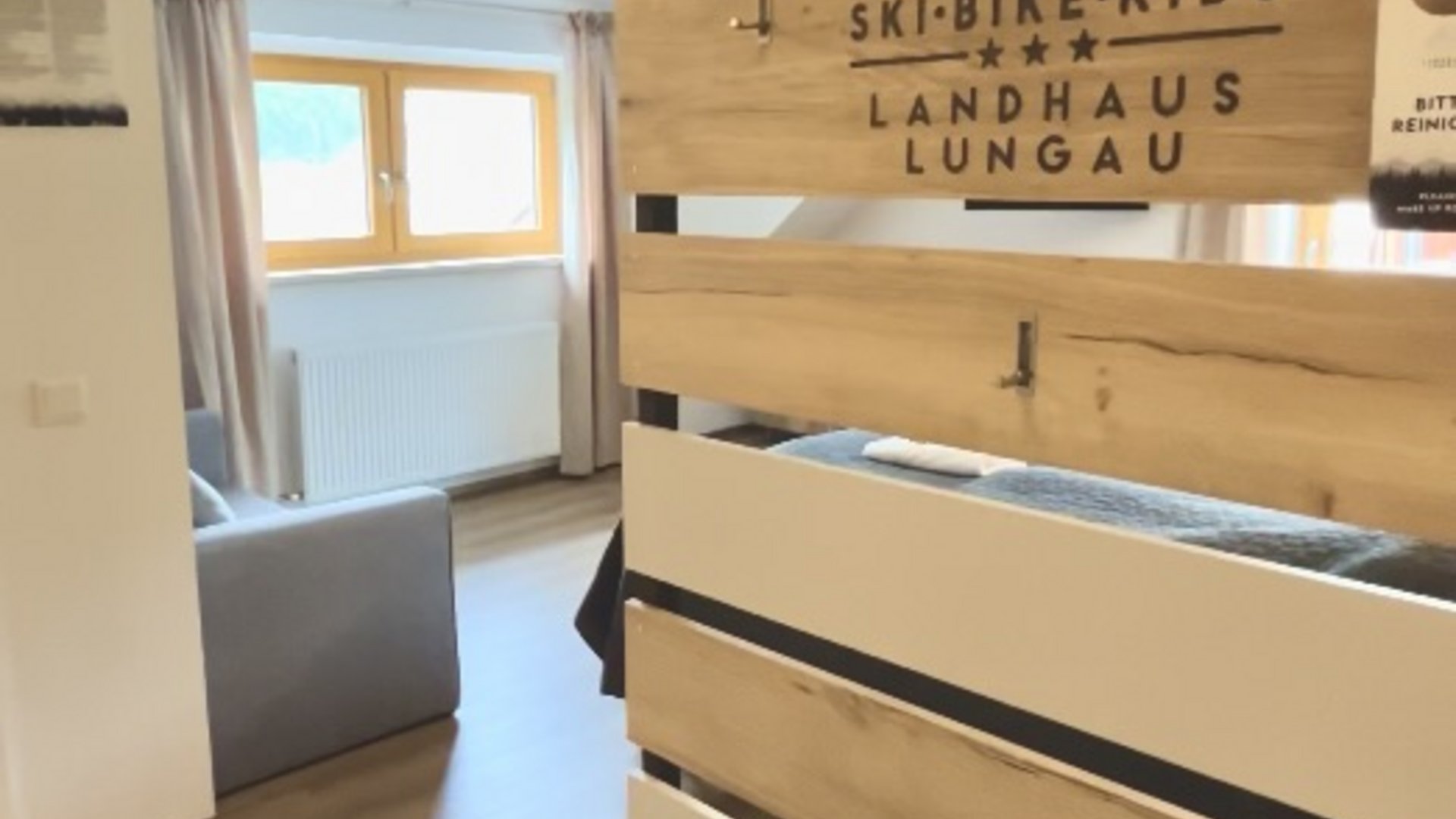 Bench and wooden sign with Ski-Bike-Kids Landhaus Lungau in interior space