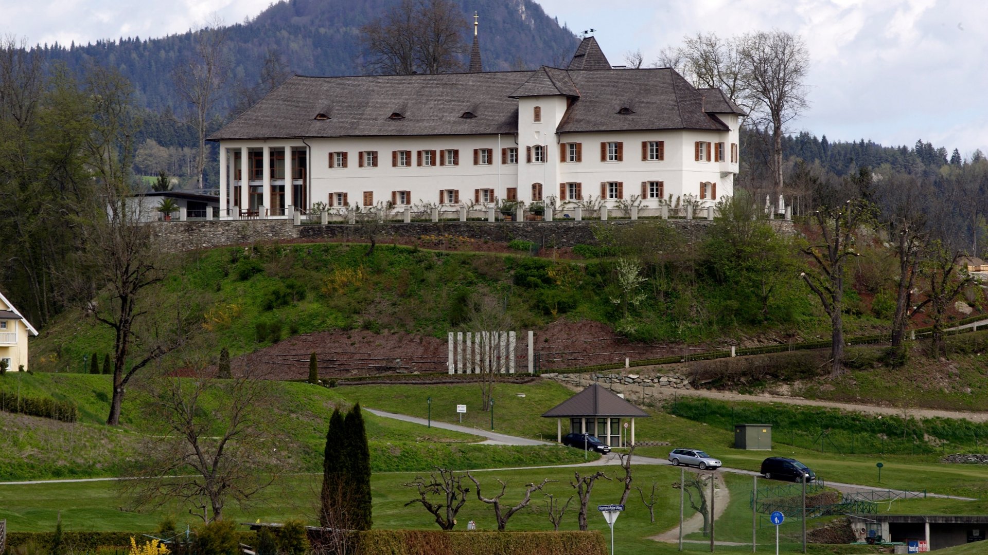 Historic castle on a hill with mountains in the background