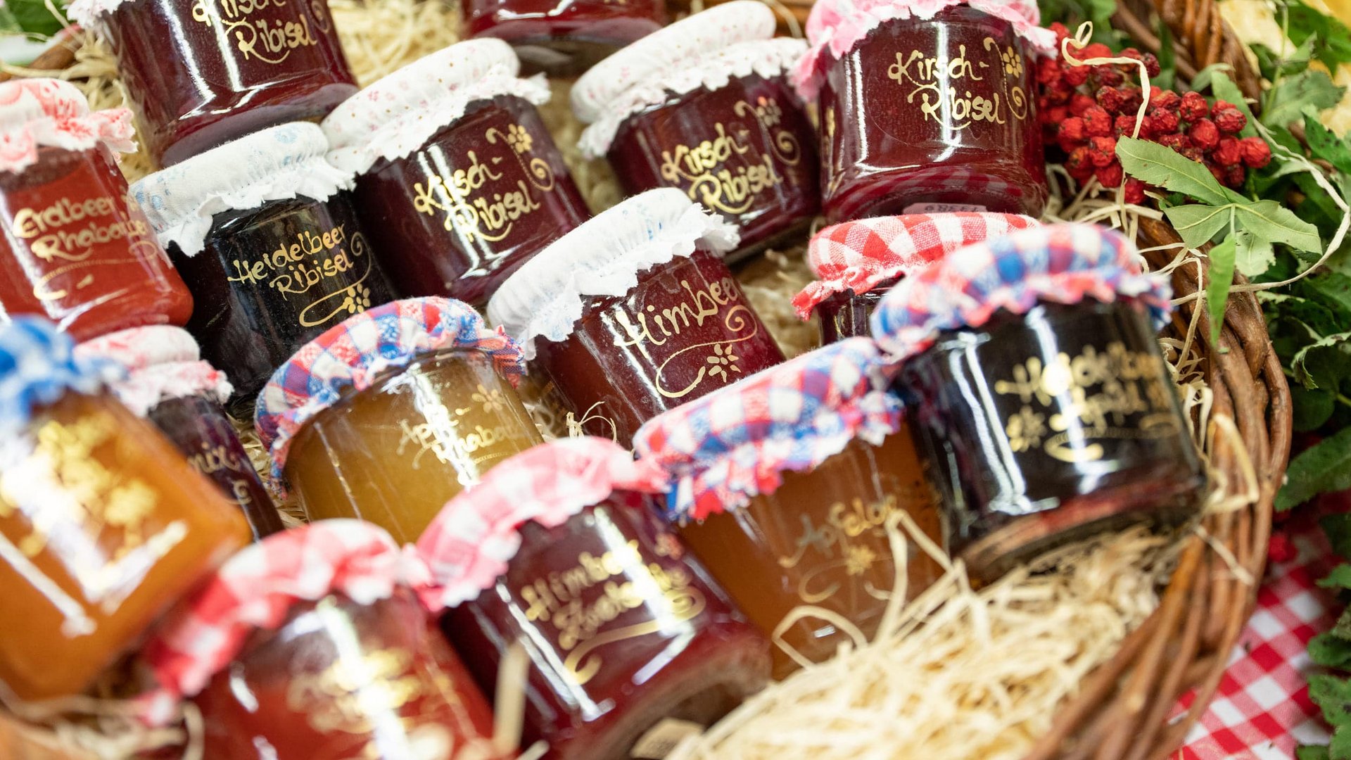 Basket with assorted jars of homemade jam