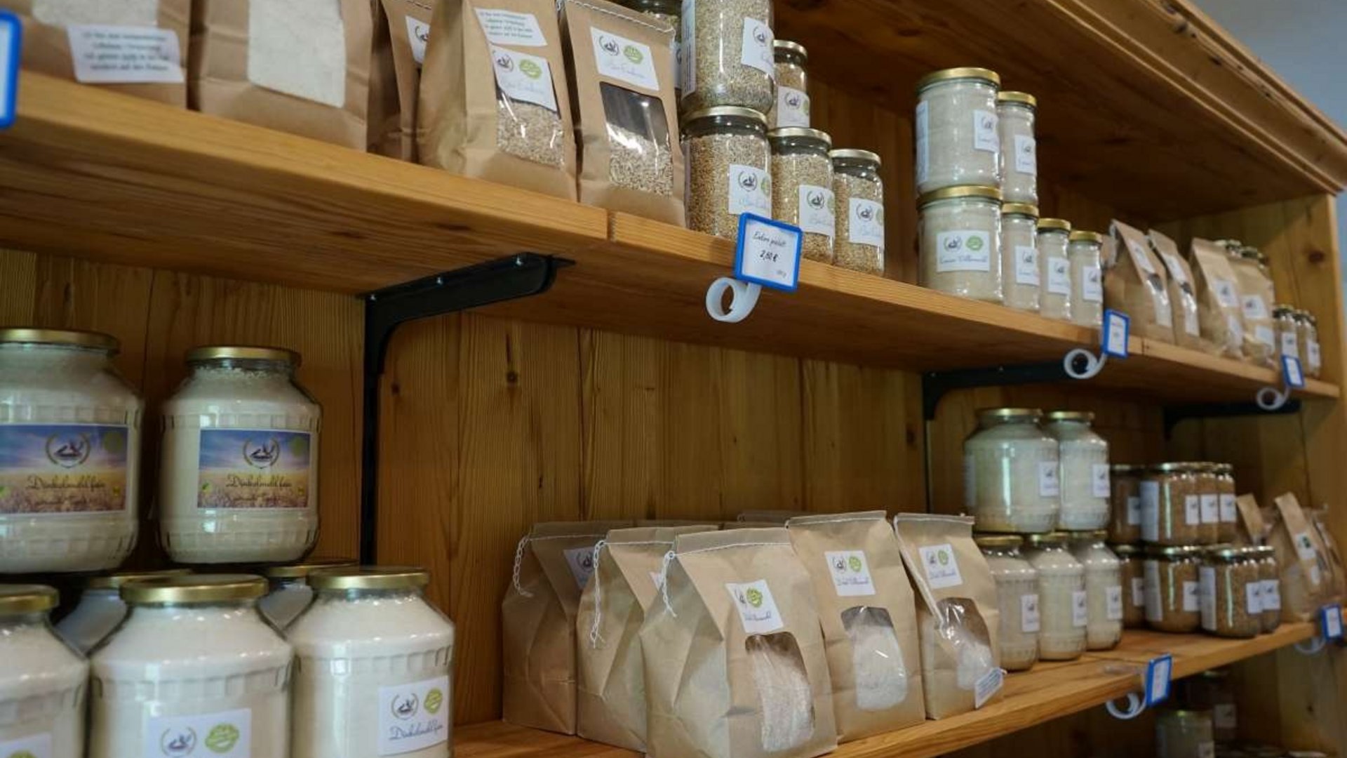 Shelves with jars and paper bags of food items