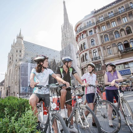 Four cyclists in front of St. Stephen's Cathedral in Vienna