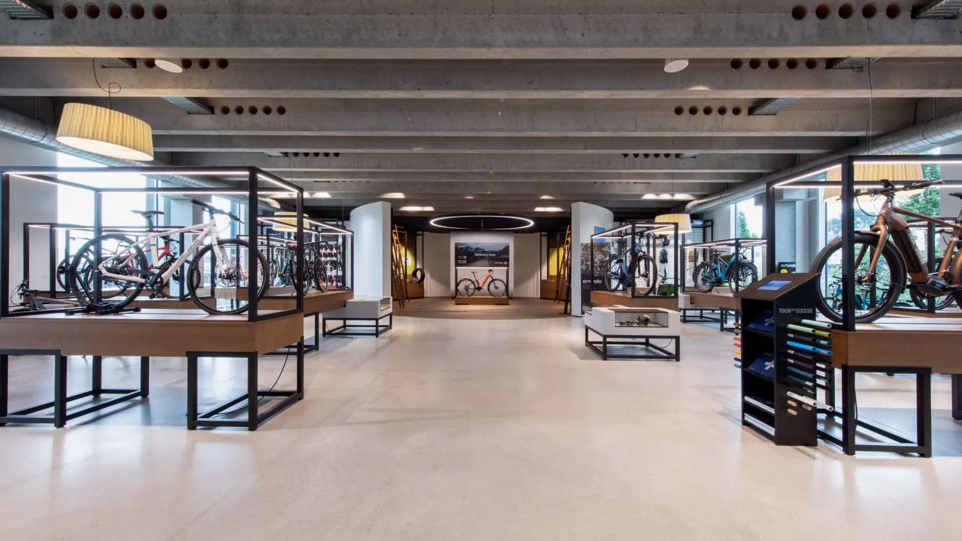 Modern bike store with e-bikes displayed in glass cases