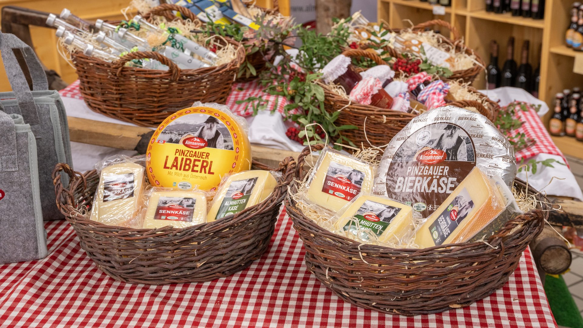 Two baskets with Austrian cheese on red and white checkered table