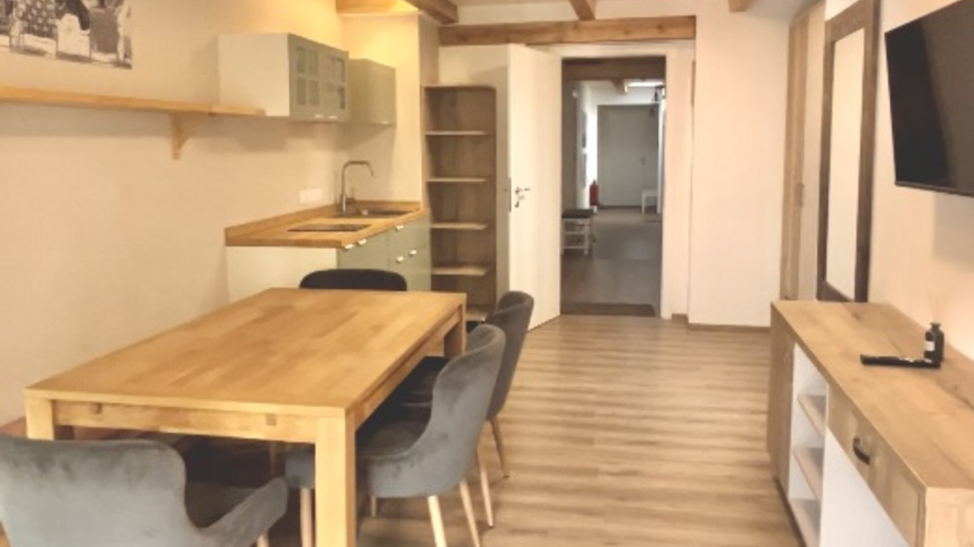 Modern dining area with wooden table and gray chairs