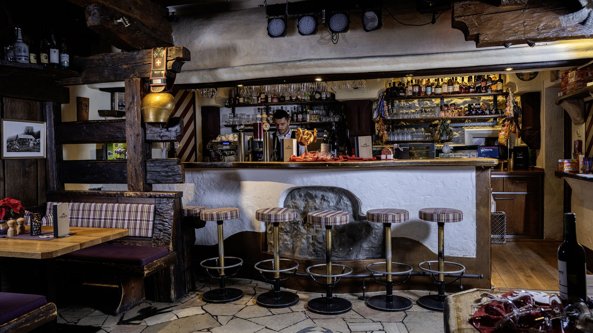 Cozy bar with rustic wooden interior and padded bar stools