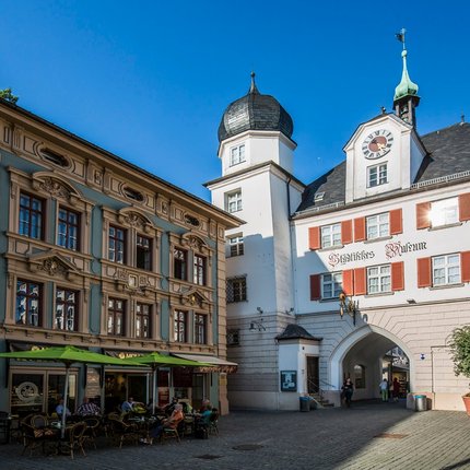City museum with café and people at historic city gate