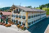Collective enquiries © Team F8 Traditional Bavarian inn with outdoor seating and flower decorations