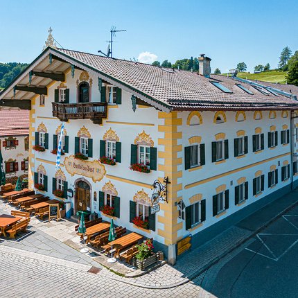 Traditional Bavarian inn with outdoor seating and flower decorations