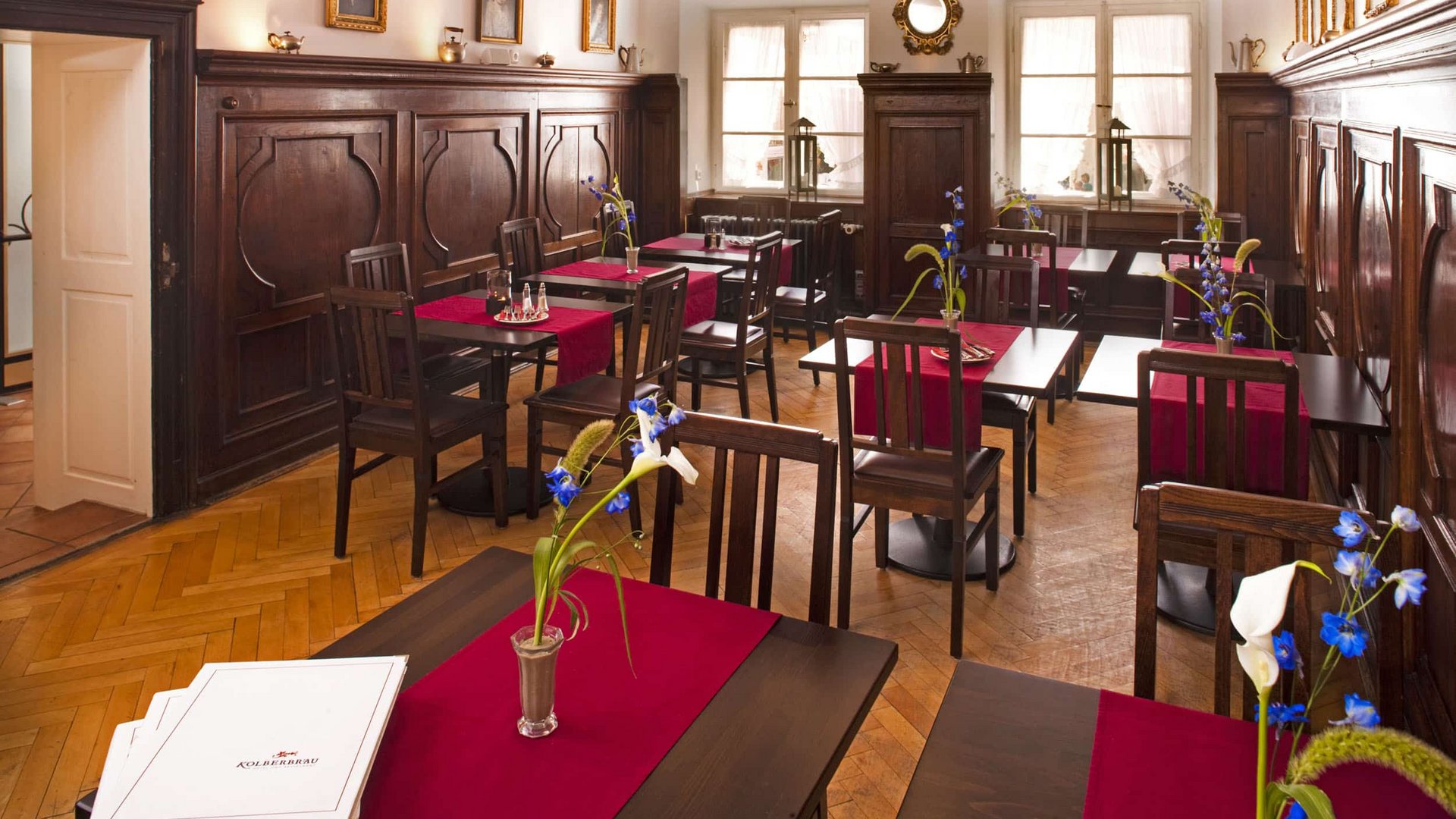 Cozy dining room with dark wood furniture and red table runners