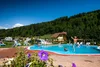 Collective enquiries © Camping Bella Austria Children jumping into a pool at a campsite surrounded by mountains