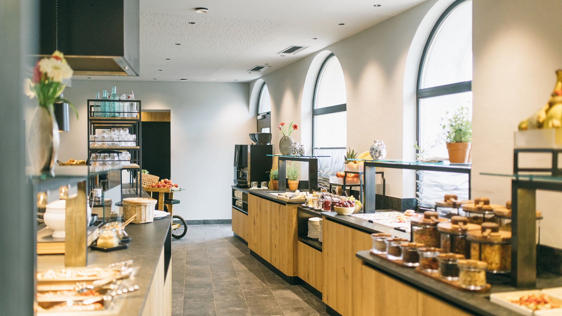 Bright breakfast buffet with wooden counters and large windows