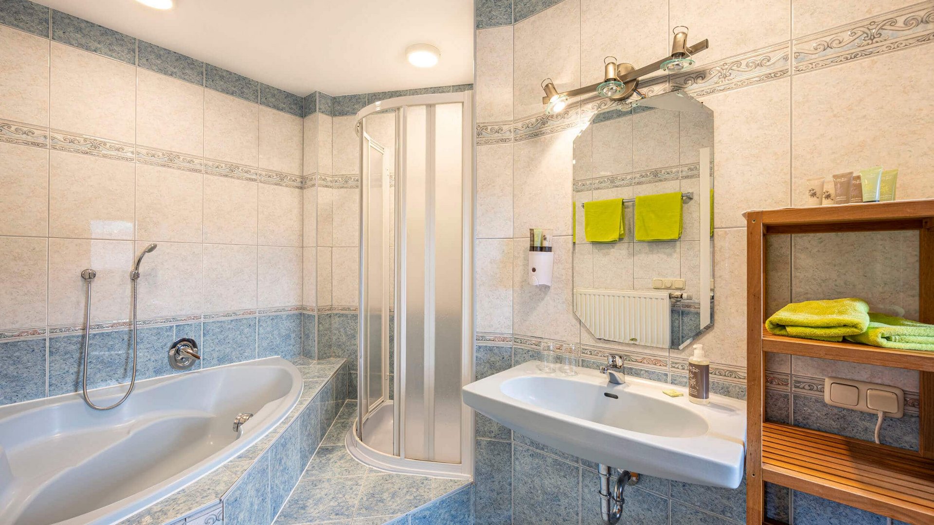Bright bathroom with bathtub, shower, sink, and towels