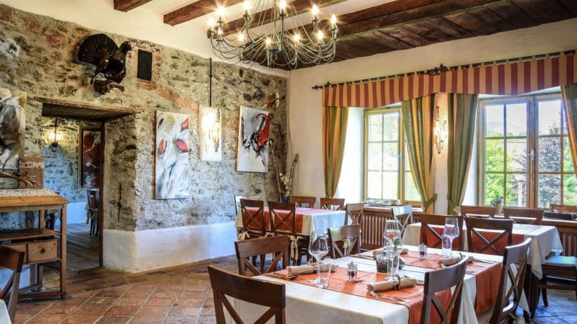 Rustic restaurant with stone walls and wooden beam ceiling