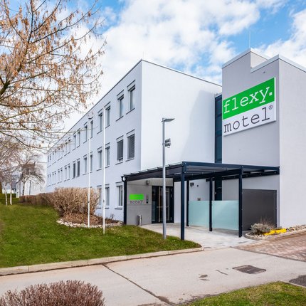 Modern Flexy Motel building with parking spaces in front