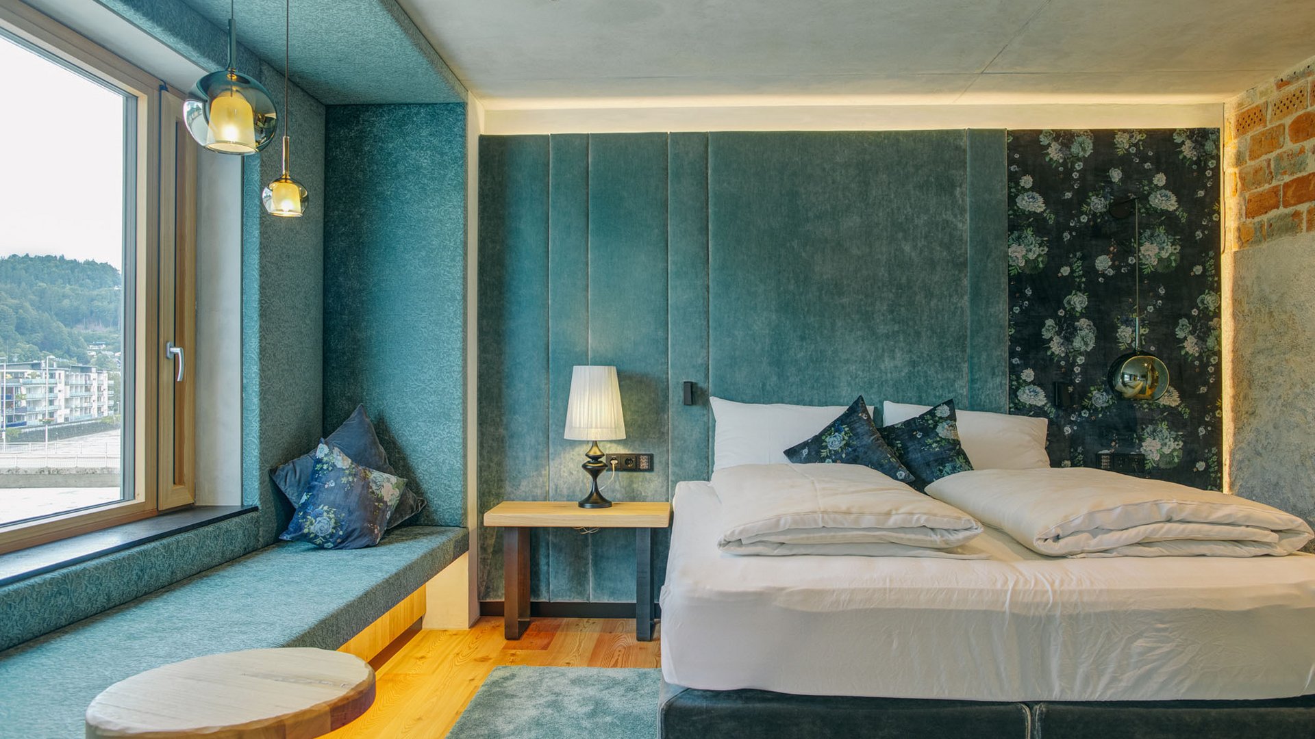 Modern bedroom with blue upholstered bed and window seating area