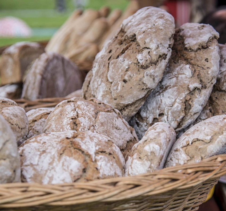 Basket filled with rustic loaves of freshly baked bread