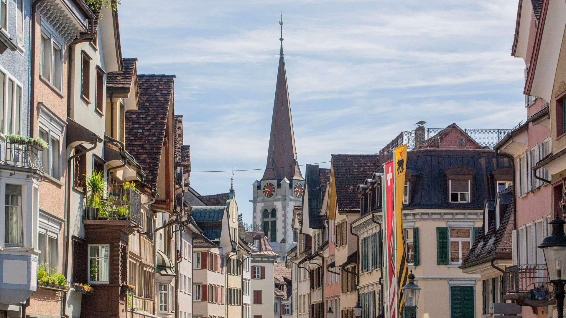 View of old town street with historic buildings and church tower