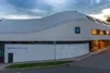 Collective enquiries © Weingut Gager Modern winery building with wavy roof at sunset