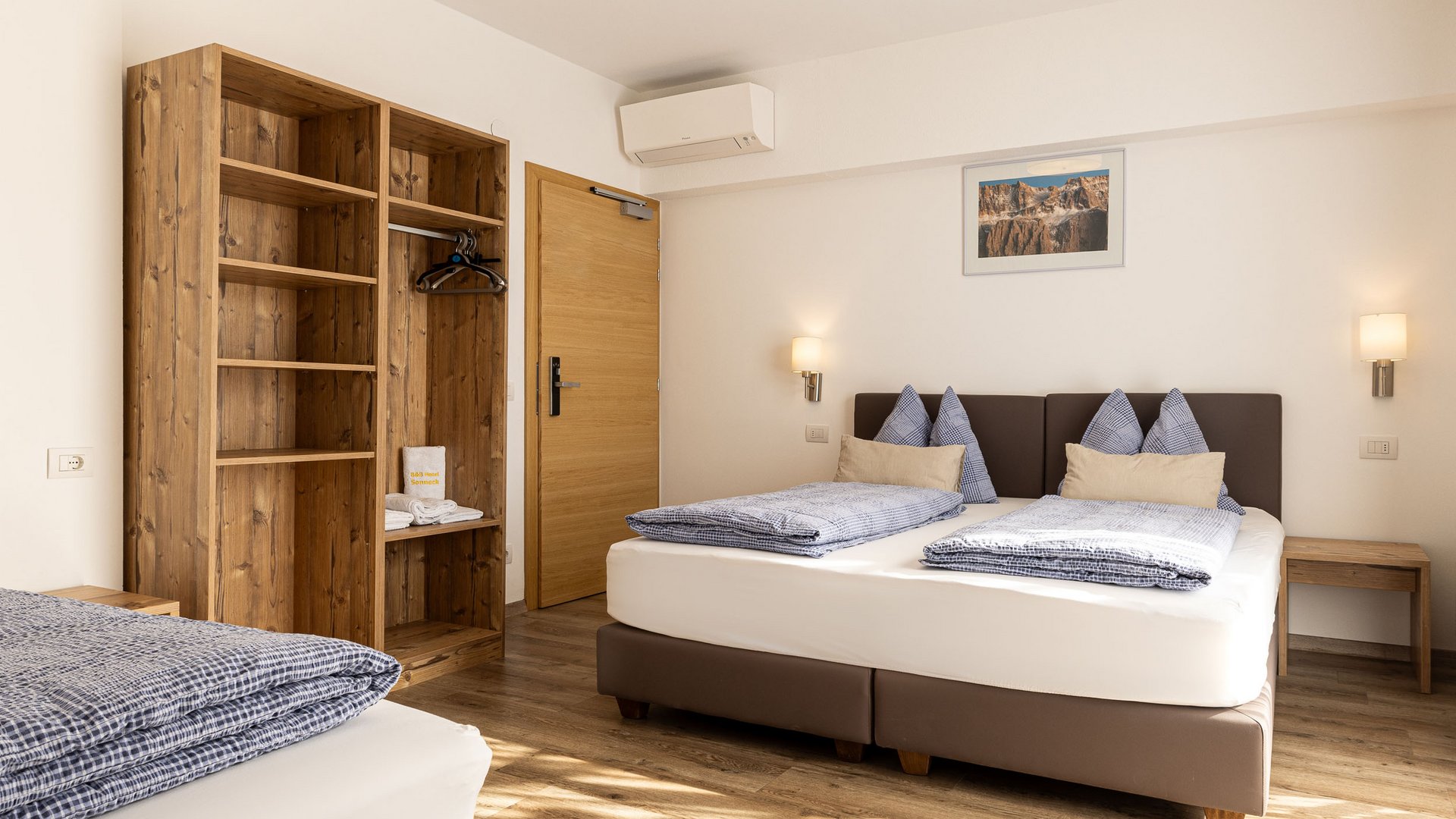 Bright bedroom with two single beds and wooden furniture