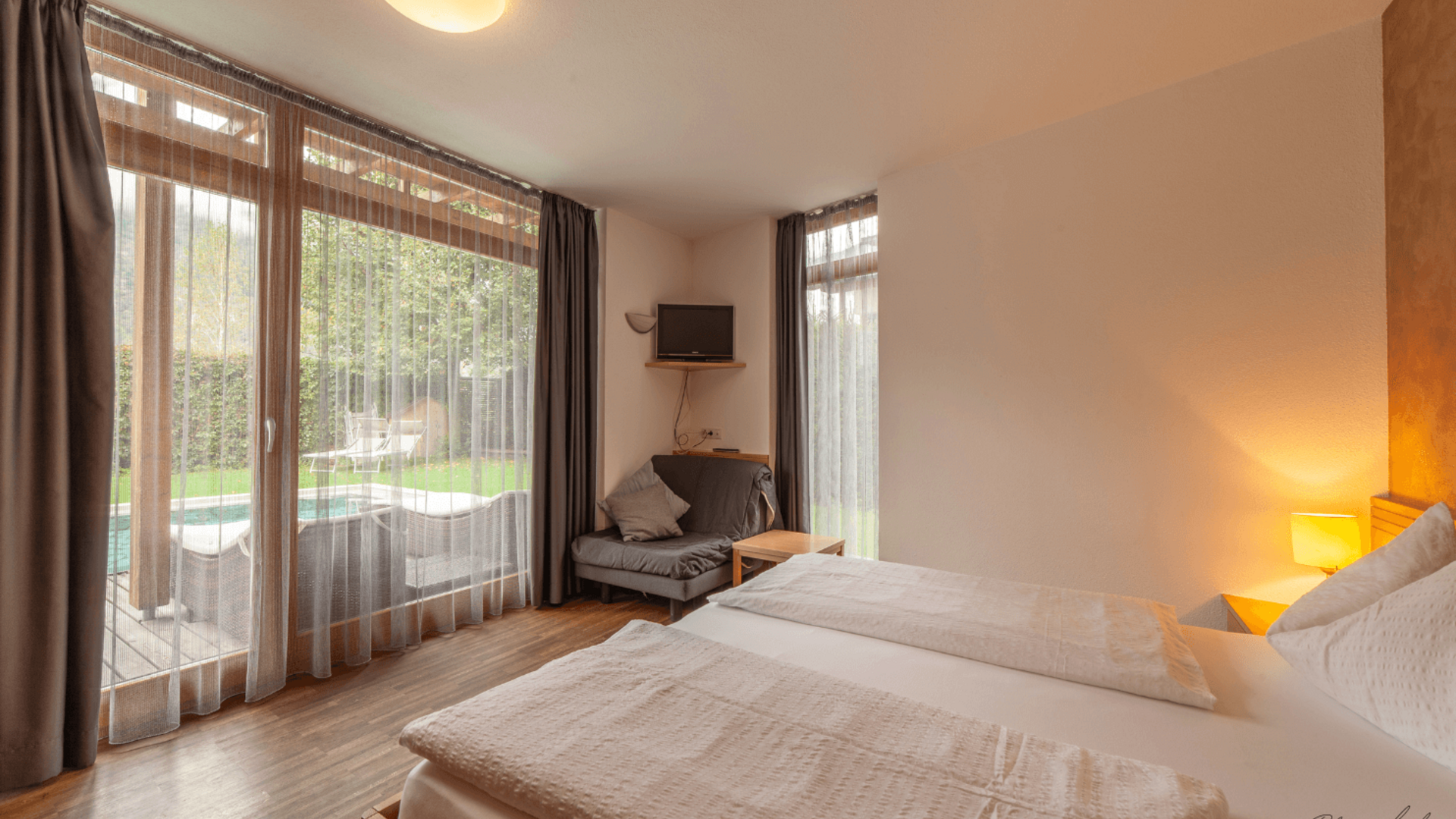 Cozy hotel room with view of terrace and garden