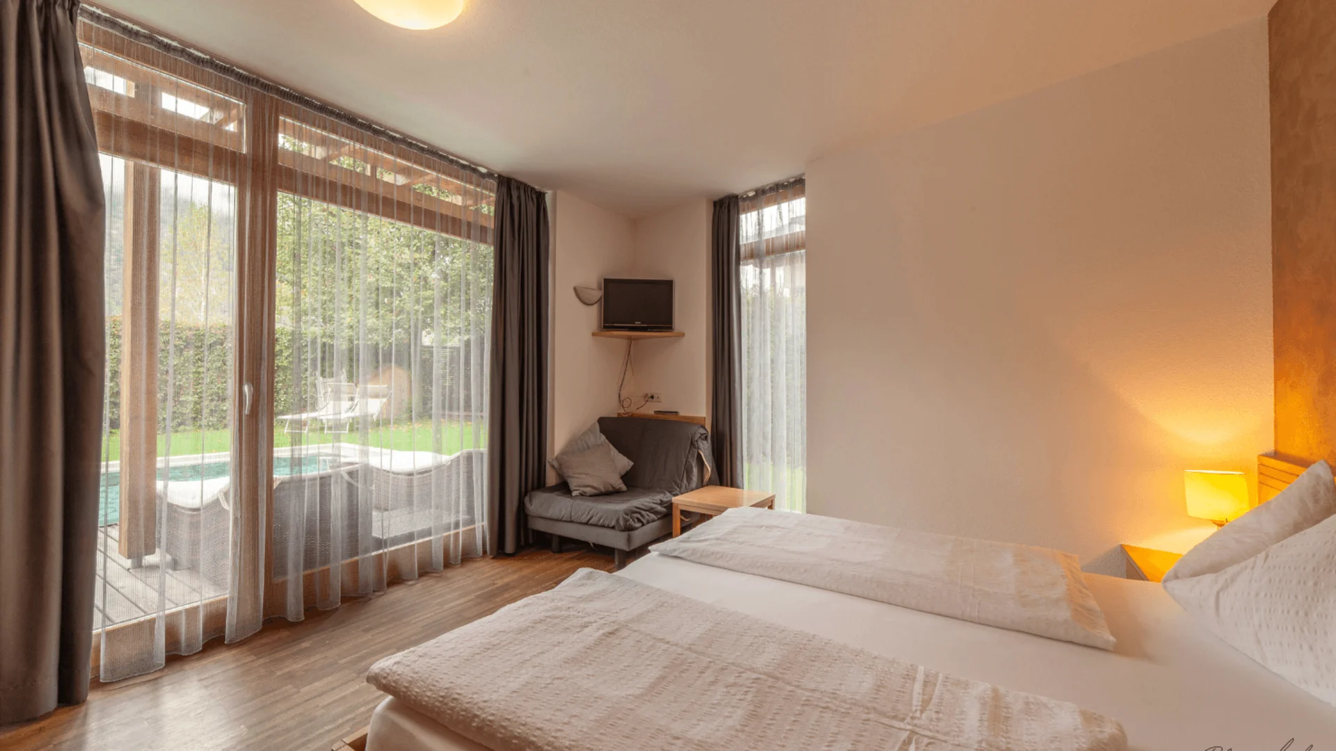 Cozy hotel room with view of terrace and garden