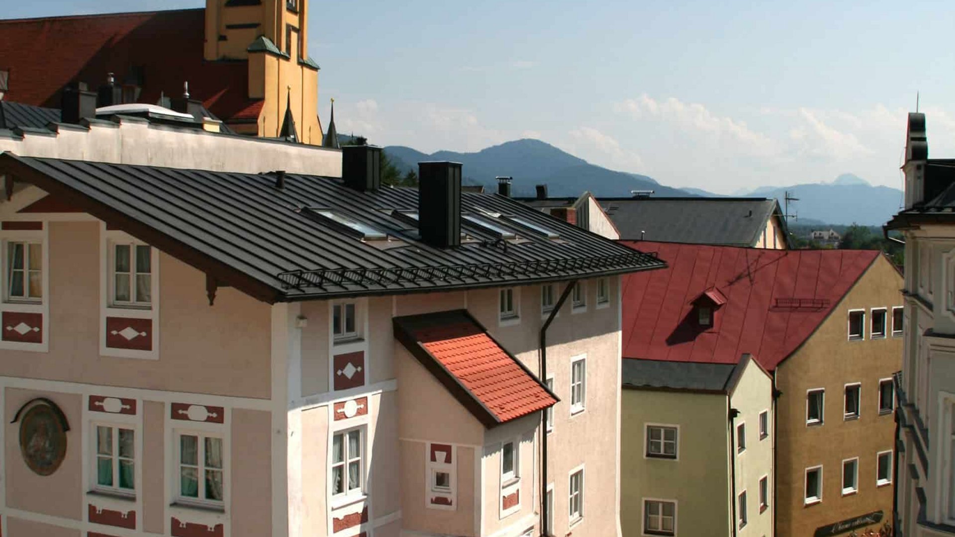Old town with church tower and traditional buildings under clear sky