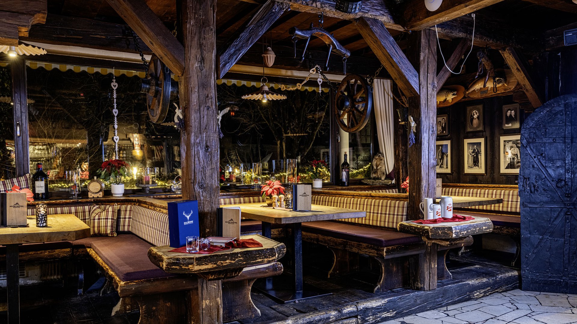 Rustic dining area with wooden furniture and checkered cushions