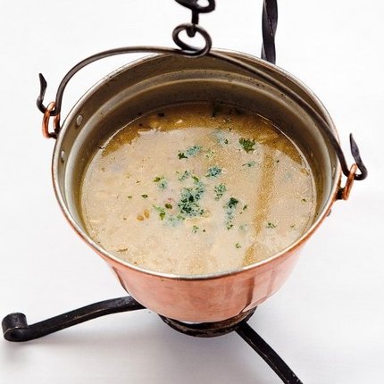 Soup served in a copper pot on a stand