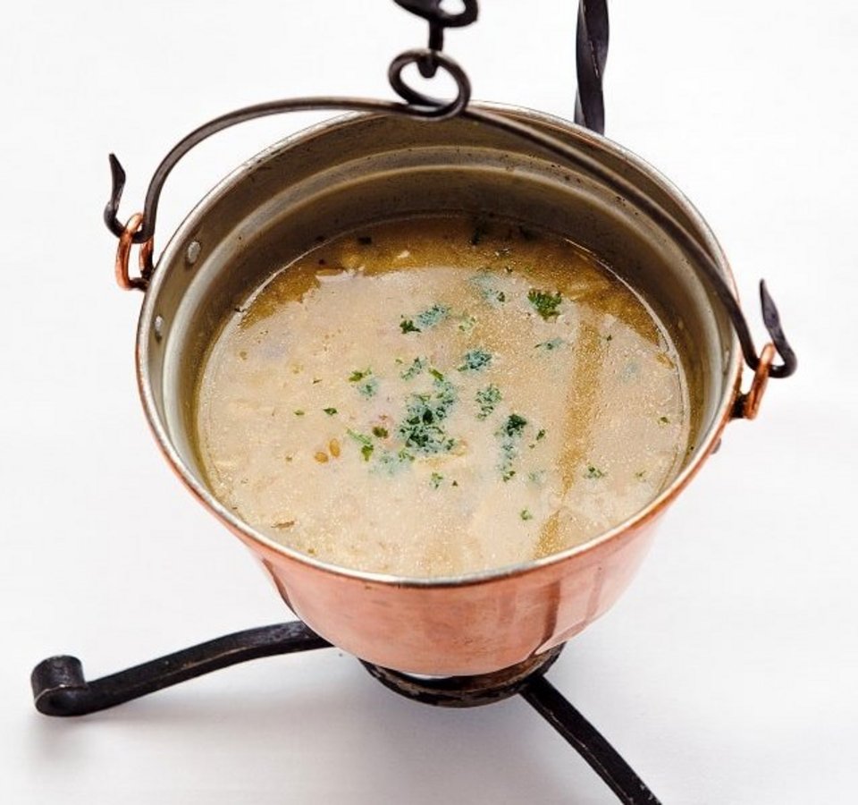 Soup served in a copper pot on a stand